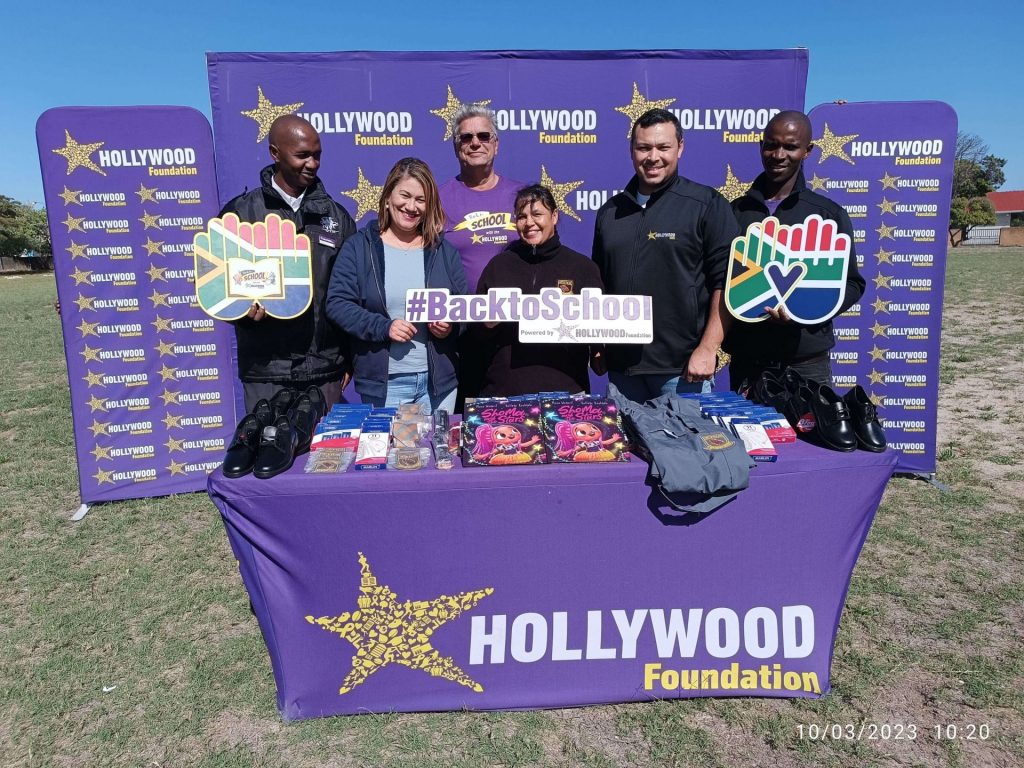 hollywoodfoundation-1. Representatives from the Hollywood Foundation and Erica Primary School with the contribution min 1Romy Titus partners with Hollywood Foundation for the Back to School campaignHollywoodbets iBranch MASTER