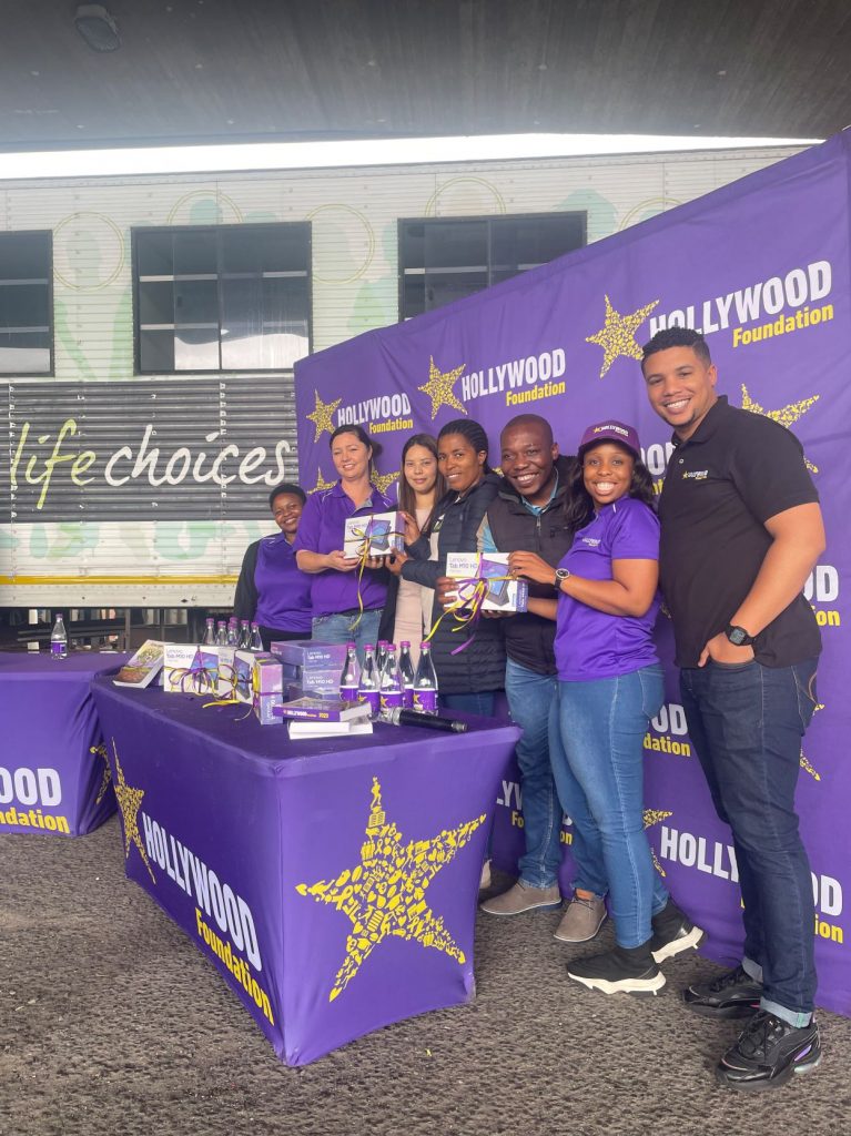hollywoodfoundation-Hollywood Foundation Team Member hands over tablets to Life Choices representativeThe Hollywood Foundation empowers the community through its heartfelt Corporate Social Investment (CSI) contribution to Life Choices organisationHollywoodbets iBranch MASTER