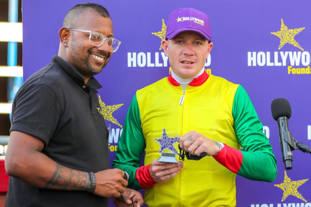 hollywoodfoundation-Rasigan-Naidoo-congratulates-a-JockeyThe Hollywood Foundation’s First Race Day2021/22 Handovers